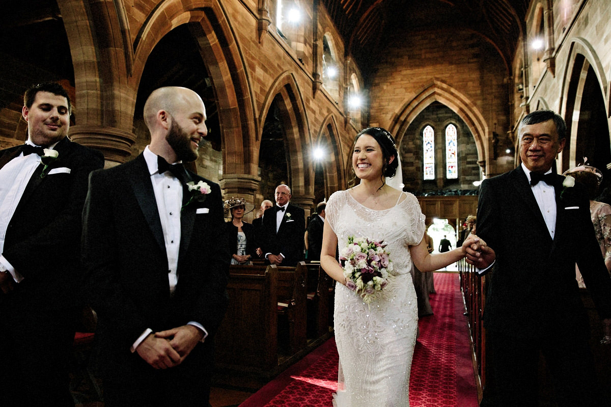 Bride seeing her groom for the first time after walking down the aisle with her father