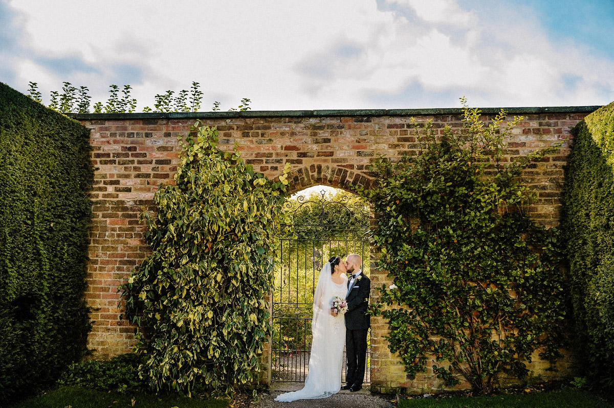 Bride and groom in the gardens at Arley Hall