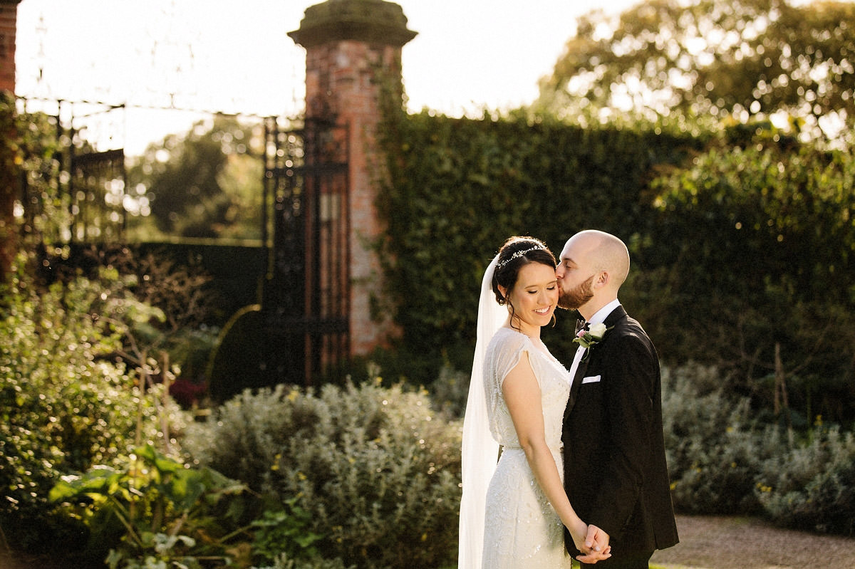 Loving moment between the bride and groom at Arley Hall and gardens