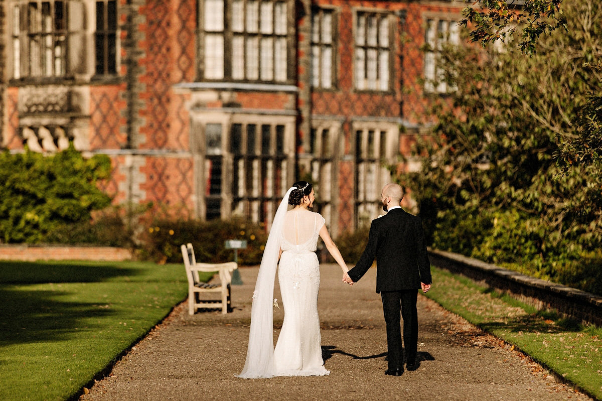 Bride and groom walking back towards Arley Hall for the wedding breakfast