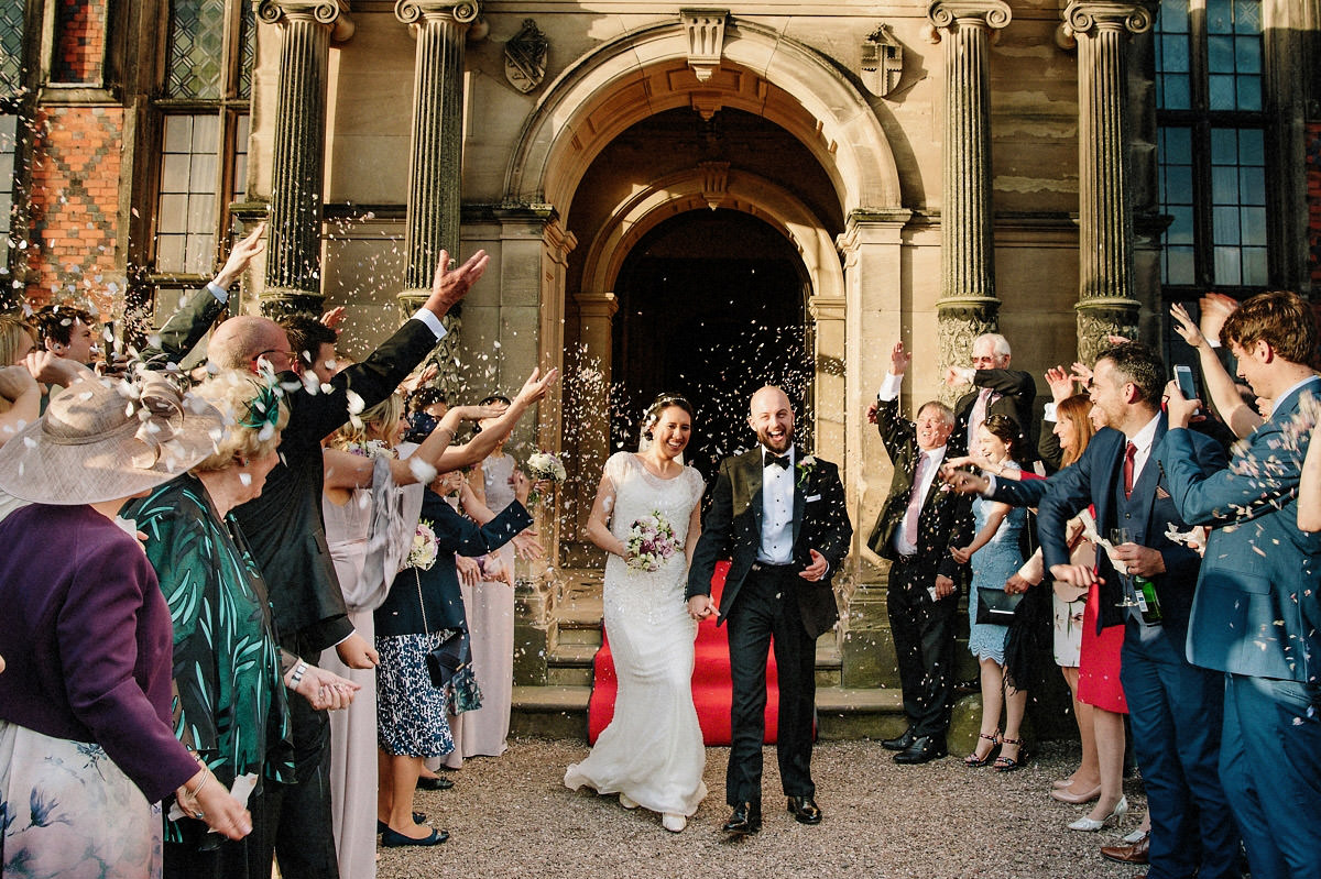 Fun confetti photo of the bride and groom and their wedding guests at Arley Hall