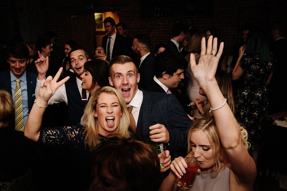 Wedding guests having fun on the dance floor at Arley Hall inside the Olympia room